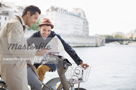 Men looking at map along Seine River, Paris, France