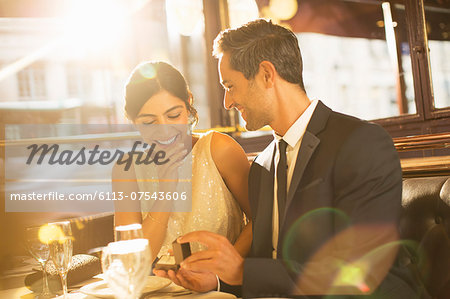 Man proposing to girlfriend in restaurant