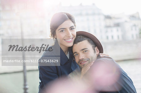 Couple hugging along Seine River, Paris, France