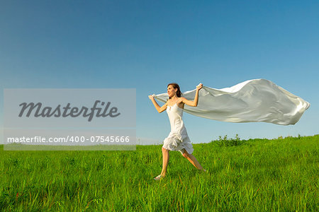 Young beautiful woman running while holding a white tissue