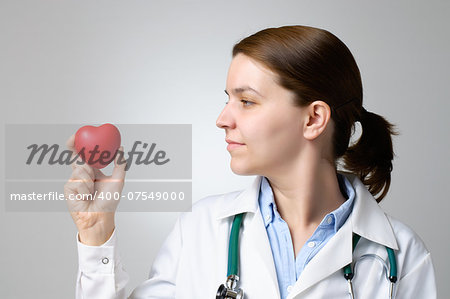 Red heart in the hand of a physician