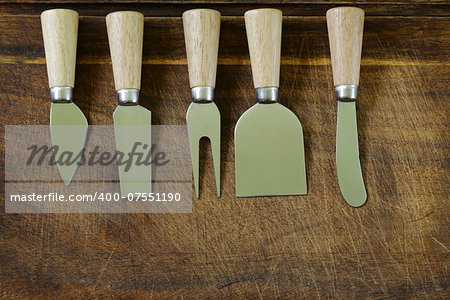 cheese knife set on a wooden background