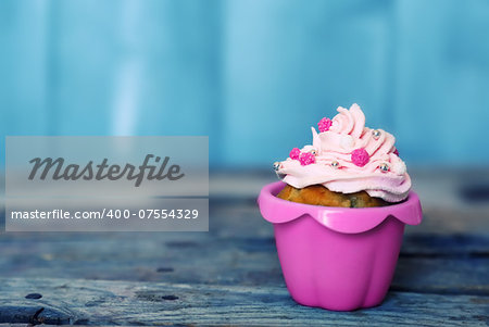 Photo of cute cupcake on wooden background