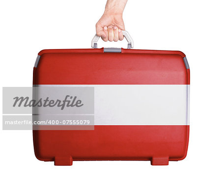 Used plastic suitcase with stains and scratches, printed with flag, Austria