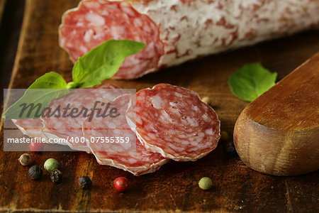 delicacy smoked sausage (salami) on a wooden board