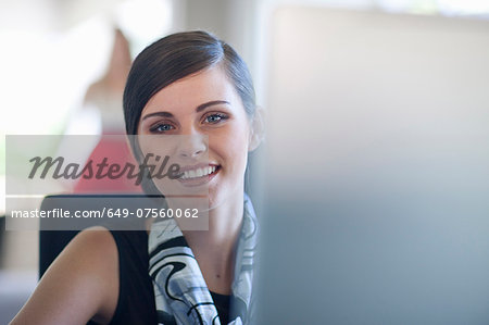 Young female office worker at computer