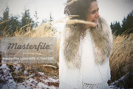 Mid adult woman wearing fur collar in forest