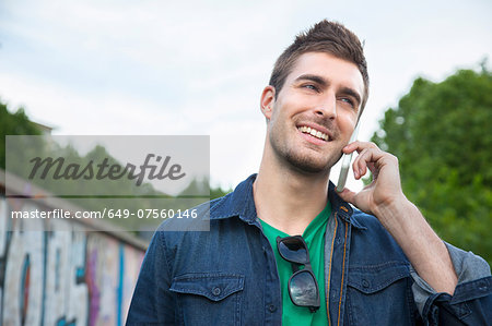 Young man talking on smartphone Young man talking on smartphone