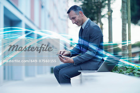 Waves of blue light and businessman texting on smartphone