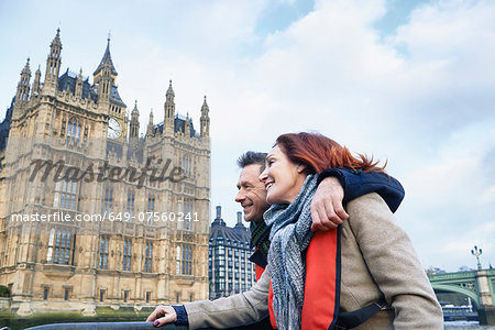 Mature couple sightseeing on Thames boat, London, UK