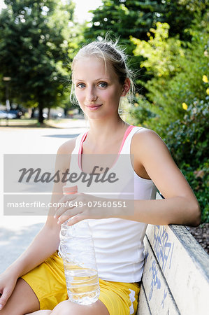Portrait of young female basketball player taking a break in park