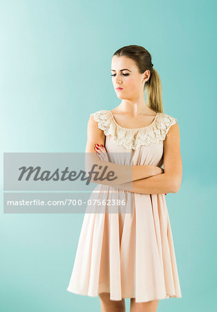 Portrait of Young Woman with Arms Crossed, Studio Shot