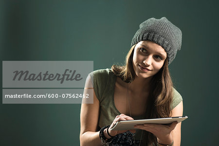 Portrait of Teenage Girl using Tablet Computer, Studio Shot