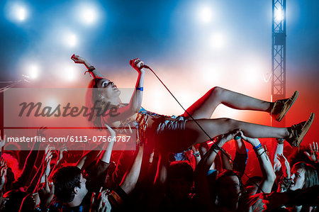 Performer crowd surfing at music festival