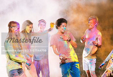 Friends covered in chalk dye at music festival