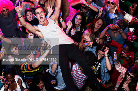 Man crowd surfing at music festival