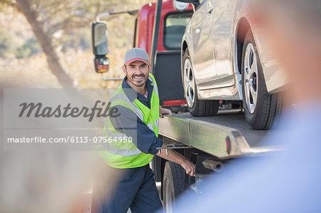Roadside mechanic towing car for senior couple
