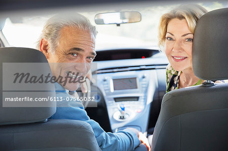 Portrait of happy senior couple inside car