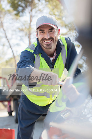 Portrait of smiling roadside mechanic