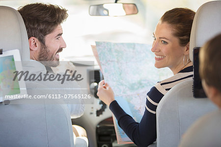 Family with map inside car