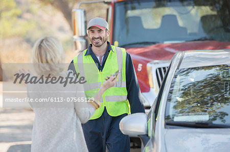 Woman greeting roadside mechanic