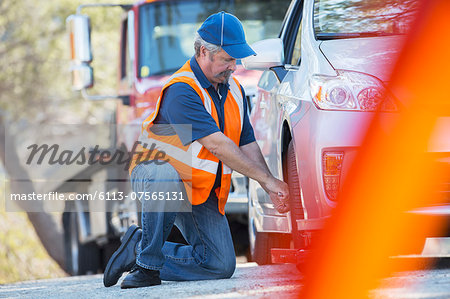 Roadside mechanic repairing flat tire