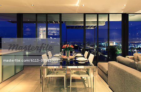 Illuminated modern dining room overlooking city