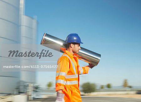 Worker carrying stainless steel tube