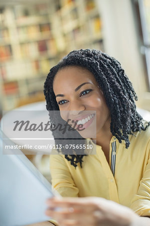 Smiling woman using digital tablet