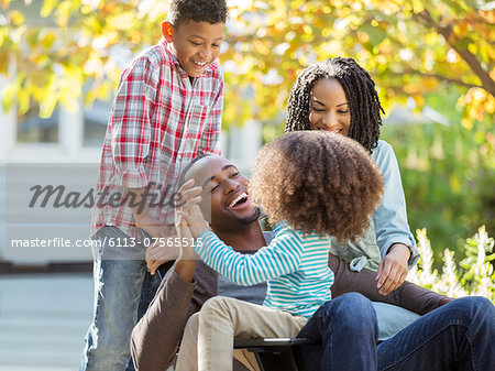 Happy family laughing outdoors