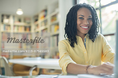 Portrait of smiling businesswoman at laptop