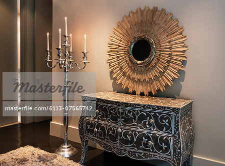 Elegant dresser, mirror and candelabra in luxury bedroom