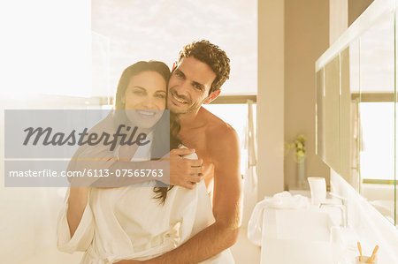 Portrait of couple hugging in bathroom