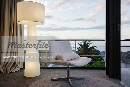 Modern floor lamp and chair in living room corner