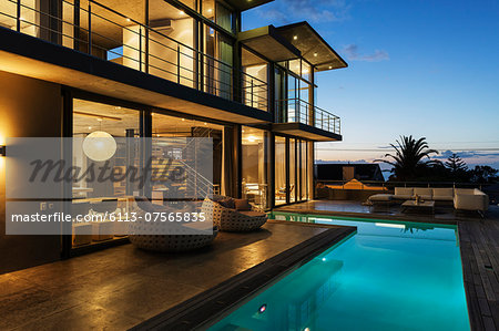 Luxury house with swimming pool illuminated at night Luxury house with swimming pool illuminated at night