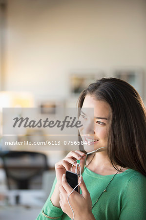 Happy businesswoman using hands-free device with cell phone