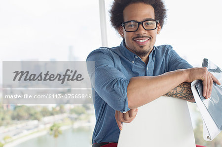 Portrait of confident businessman holding folder