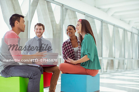 Creative business people meeting on colorful stools