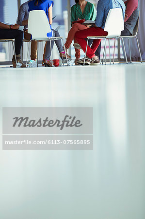 Creative business people meeting in circle of chairs Creative business people meeting in circle of chairs