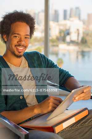 Portrait of confident casual businessman using digital tablet