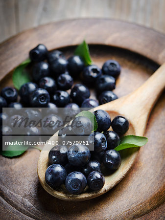 Fresh blueberries in wooden spoon