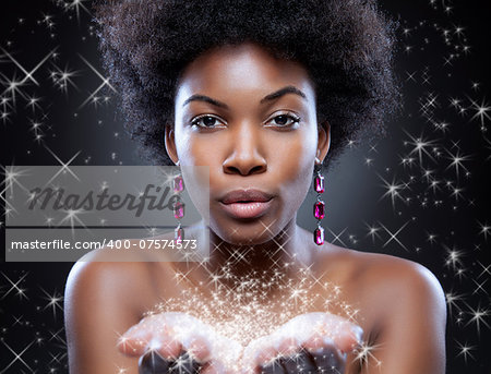 Beautiful young black woman making magic happen