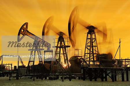 Pump jacks  at sunset sky background.