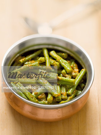 close up of a bowl of vegetarian indian long bean masala curry