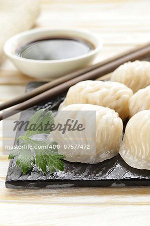 Asian steamed meat dumplings dim sum with soy sauce