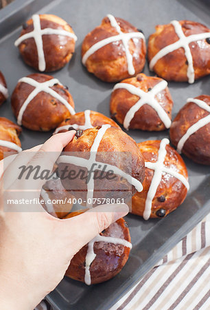 Easter hot cross buns in the hand