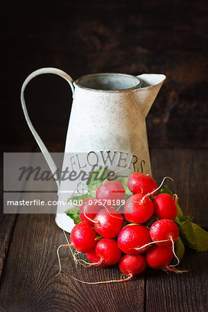 Bunch of fresh radishes on an old garden board.