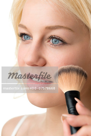 Closeup makeup applying of a blond woman