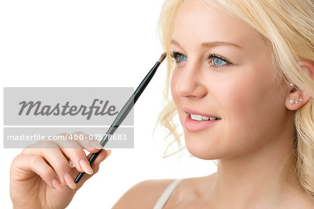 Closeup makeup applying of a blond woman