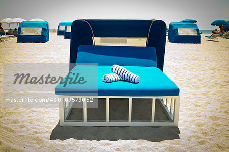 Luxurious beach bed with canopy on a sandy beach